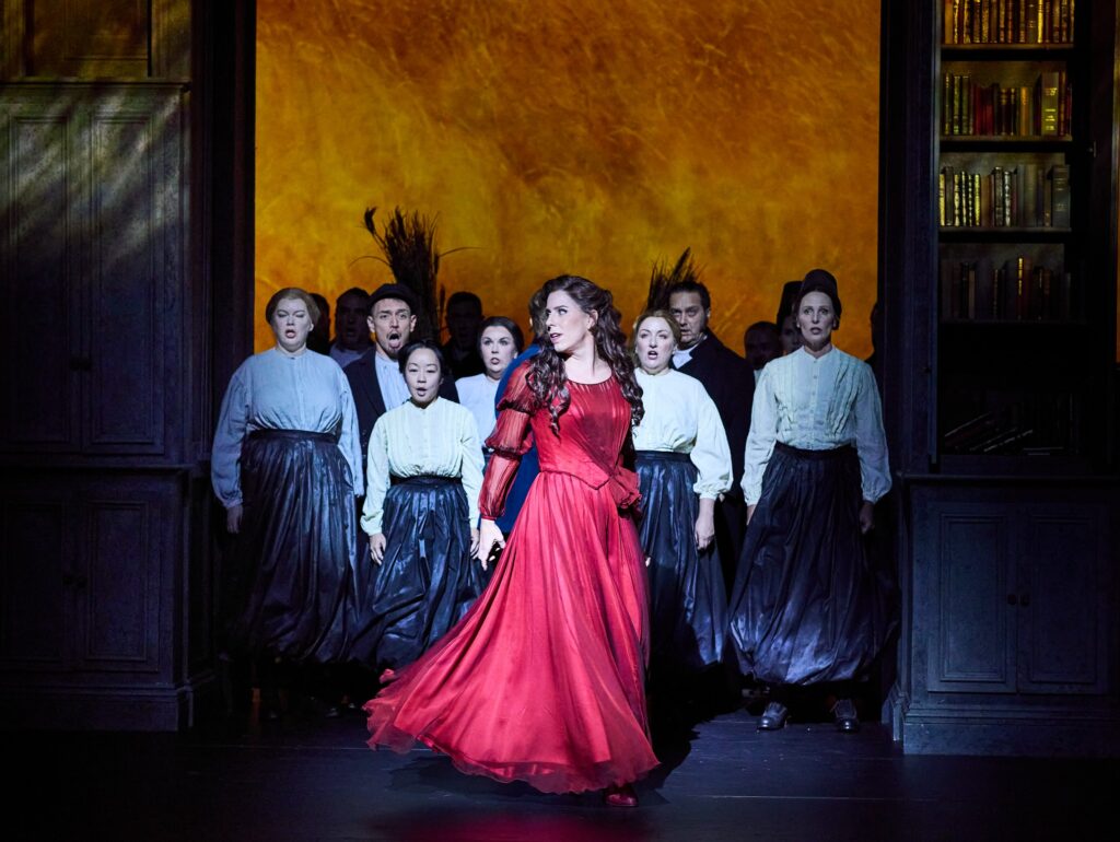 Lauren Fagan as Tatyana and Opera Australia Chorus in Opera Australia's production of Eugene Onegin 2026. Copyright: Keith Saunders